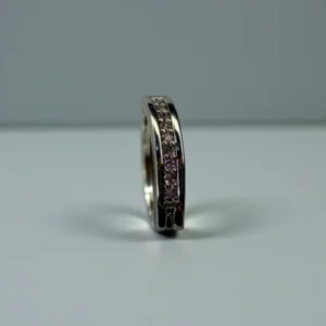 Pink gemstone belly button jewelry with polished silver barbell and sparkling navel ring design