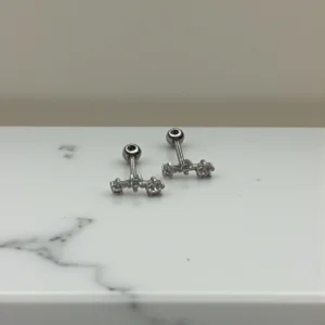 Three zircon screw bead stud with polished metal setting and triple sparkling stone design.